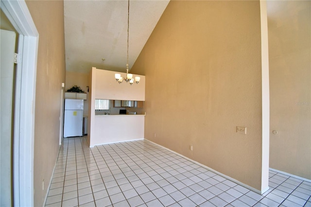 interior space featuring an inviting chandelier and high vaulted ceiling