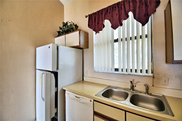 kitchen with sink and white appliances