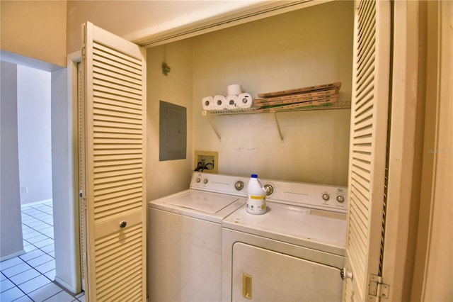 washroom with electric panel, washer and dryer, and light tile patterned flooring