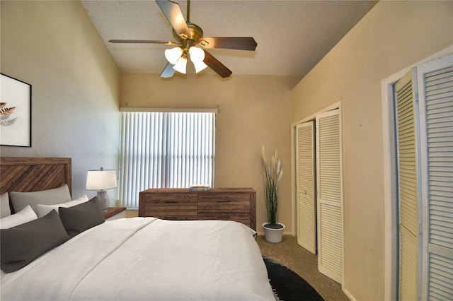 carpeted bedroom with ceiling fan and a closet