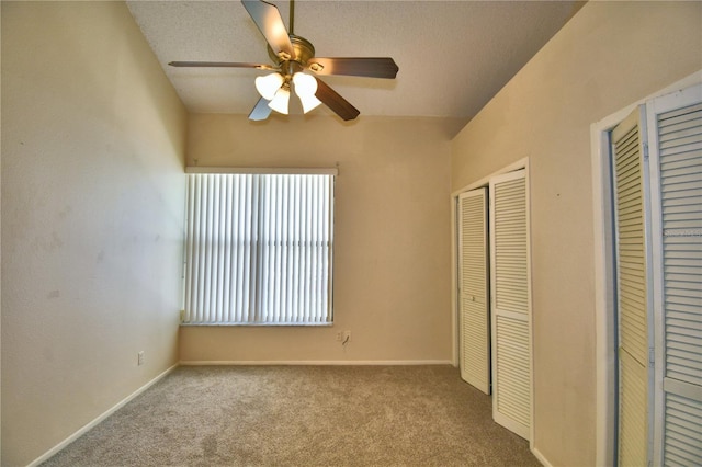 unfurnished bedroom with ceiling fan, light carpet, and a closet