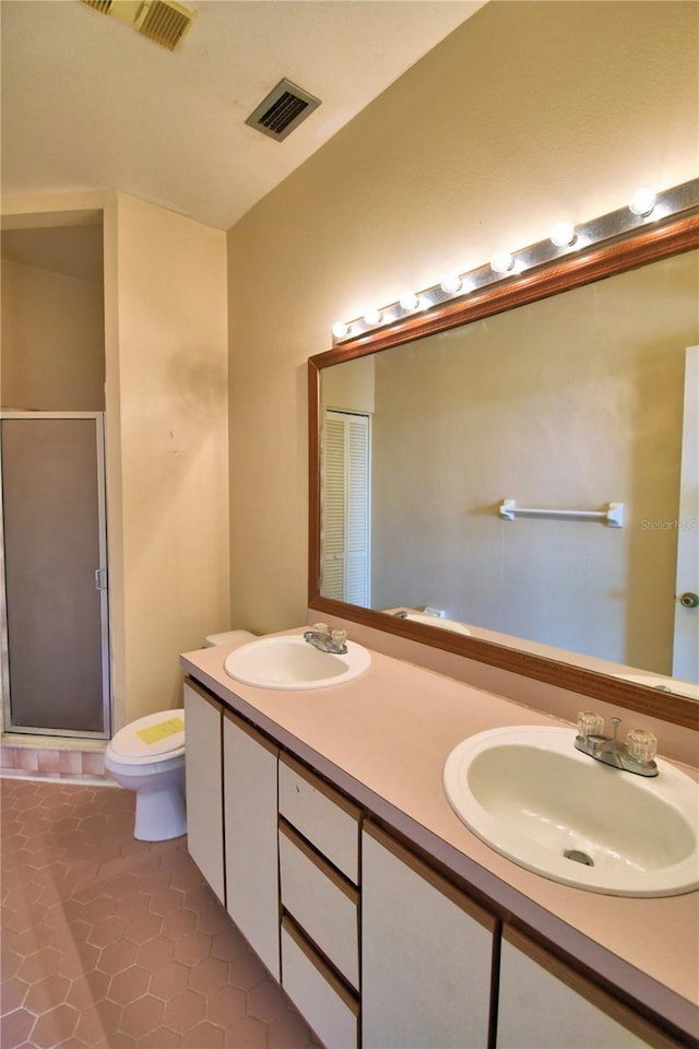 bathroom with walk in shower, vanity, toilet, and tile patterned flooring