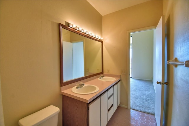 bathroom featuring tile patterned floors, vanity, and toilet