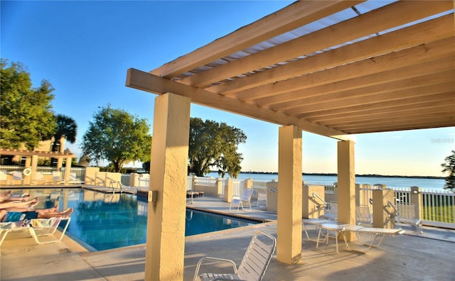 view of pool with a water view, a pergola, and a patio area