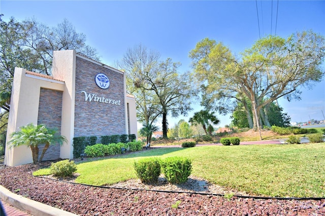 community sign featuring a lawn