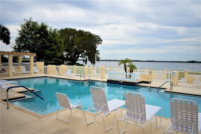 view of swimming pool with a water view and a patio area