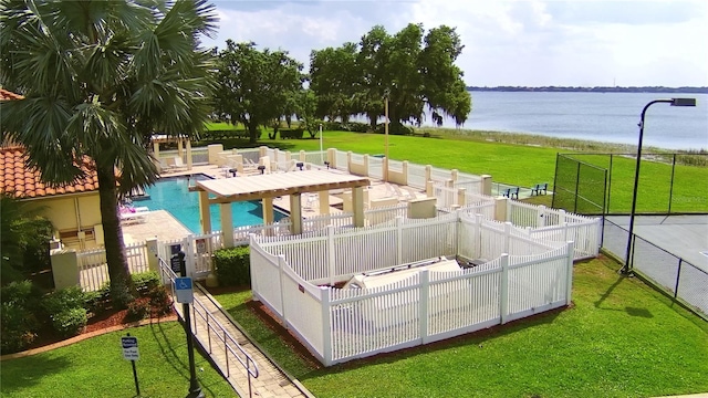 view of swimming pool with a water view, a yard, and a patio