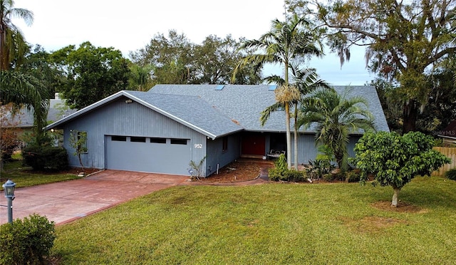 ranch-style home featuring a garage and a front lawn