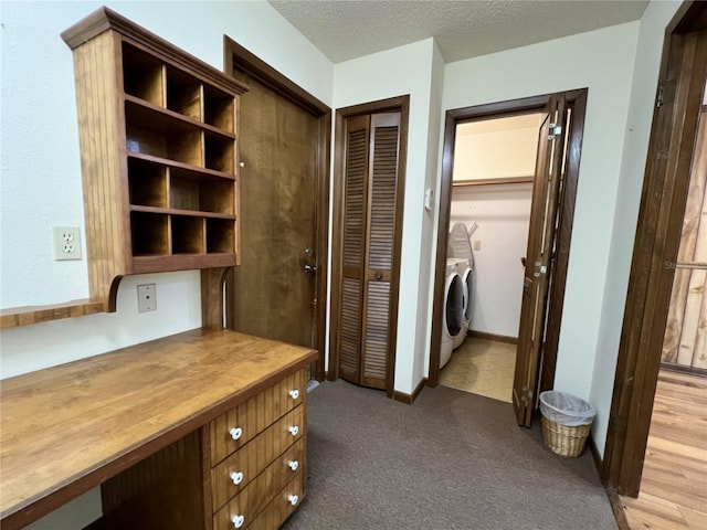 hallway featuring a textured ceiling and independent washer and dryer