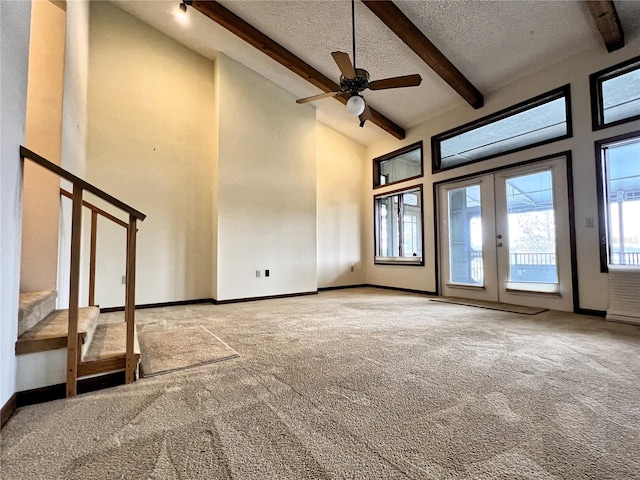 unfurnished living room with high vaulted ceiling, beam ceiling, light colored carpet, a textured ceiling, and french doors