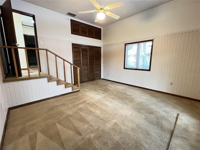 interior space with ceiling fan