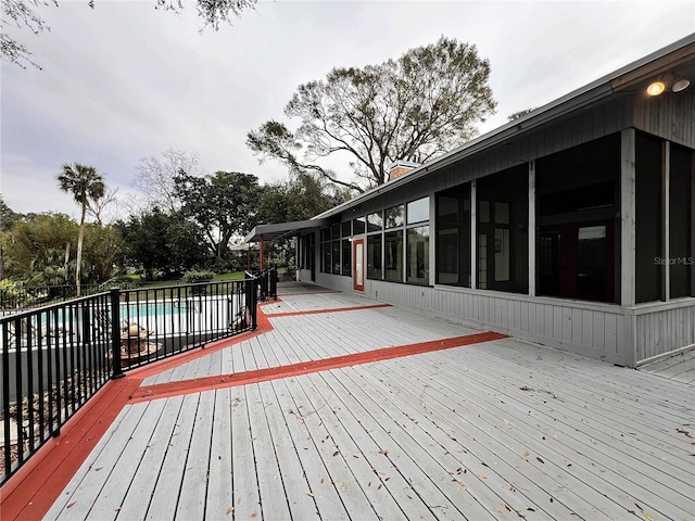 wooden deck featuring a sunroom