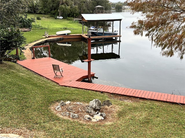 dock area featuring a lawn and a water view