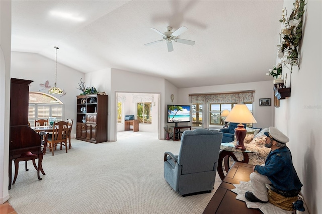 living room with lofted ceiling, light carpet, and ceiling fan