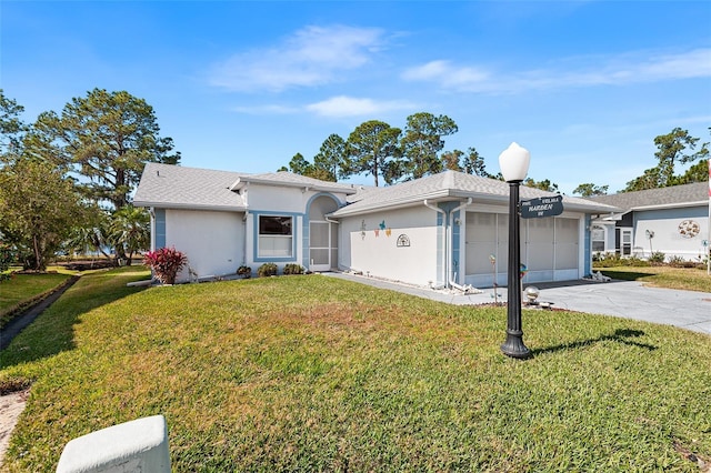 single story home featuring a garage and a front lawn