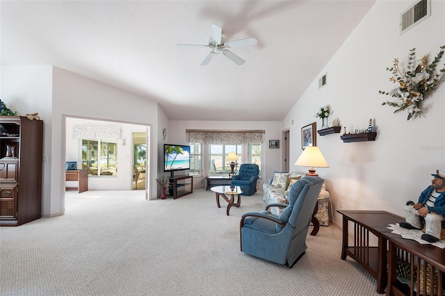 living room with vaulted ceiling, light carpet, and ceiling fan