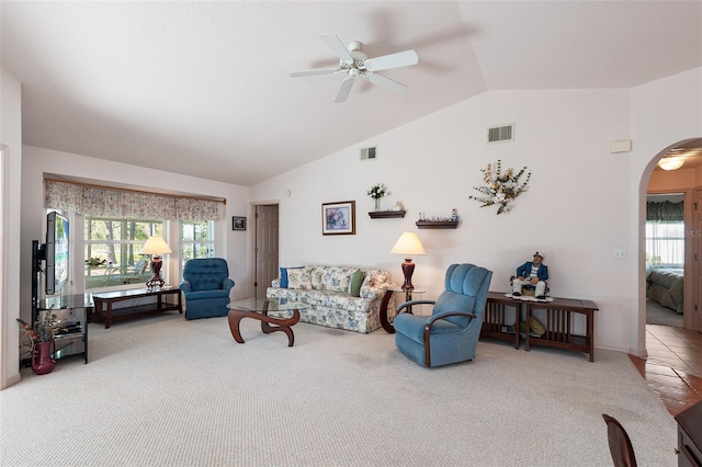 living room featuring carpet floors, vaulted ceiling, and plenty of natural light