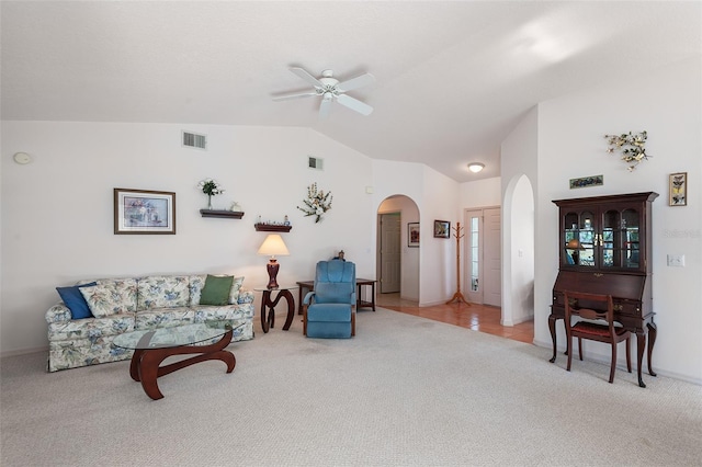 living room featuring vaulted ceiling, ceiling fan, and carpet flooring