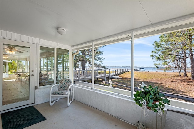 unfurnished sunroom featuring a water view and plenty of natural light