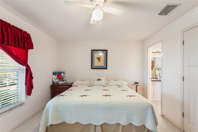 bedroom with light colored carpet, a textured ceiling, and ceiling fan