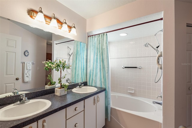 bathroom with vanity, shower / tub combo with curtain, and a textured ceiling