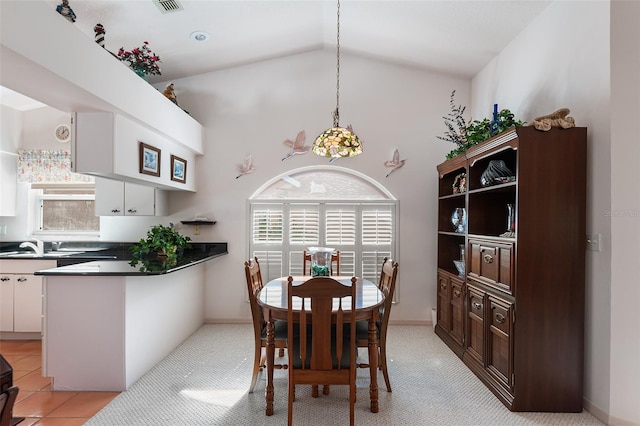 dining room featuring sink, high vaulted ceiling, and a wealth of natural light