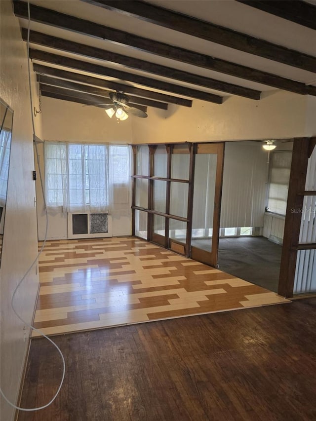 interior space featuring vaulted ceiling with beams, ceiling fan, and light wood-type flooring