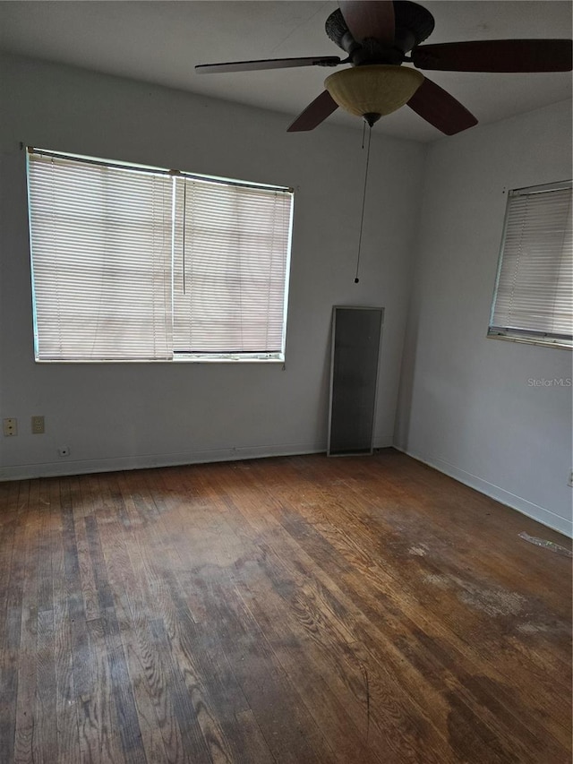 unfurnished room with dark hardwood / wood-style floors and ceiling fan