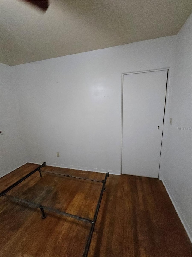 empty room with hardwood / wood-style floors