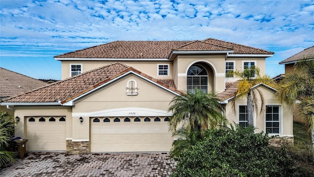 mediterranean / spanish house with a garage