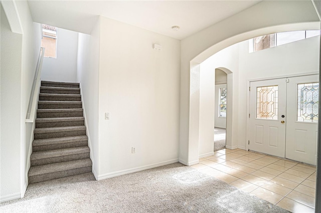 carpeted foyer with a healthy amount of sunlight