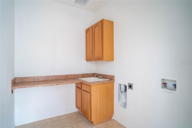 clothes washing area featuring sink, cabinets, light tile patterned floors, electric dryer hookup, and washer hookup