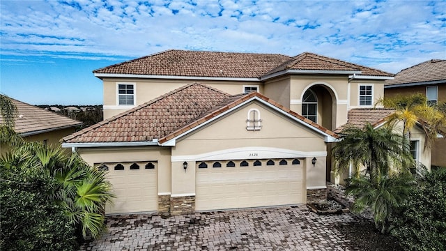 mediterranean / spanish house with a garage