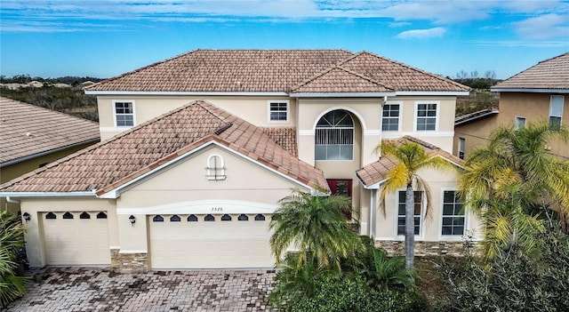 mediterranean / spanish-style home with a garage