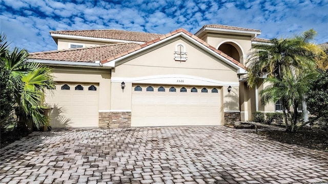 mediterranean / spanish home featuring a garage