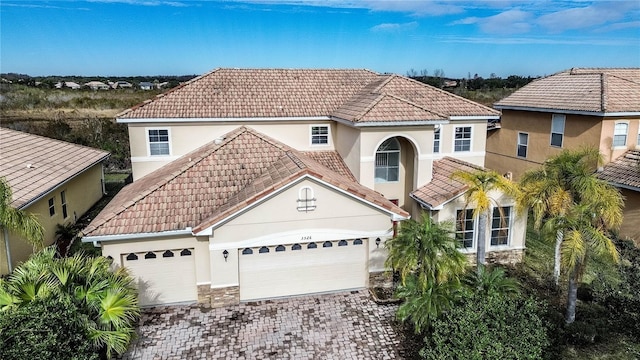 mediterranean / spanish-style house featuring a garage