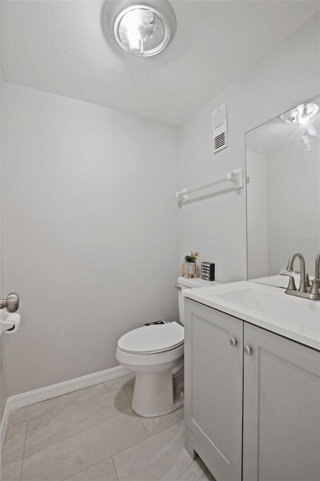 bathroom with tile patterned floors, vanity, and toilet