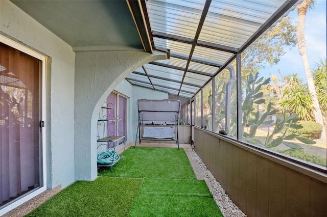 unfurnished sunroom featuring lofted ceiling