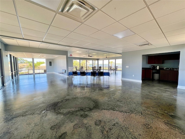 interior space with a paneled ceiling