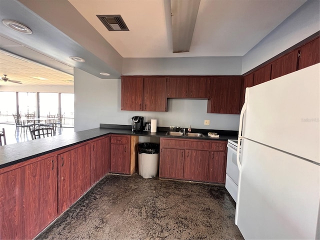 kitchen with ceiling fan, white appliances, kitchen peninsula, and sink