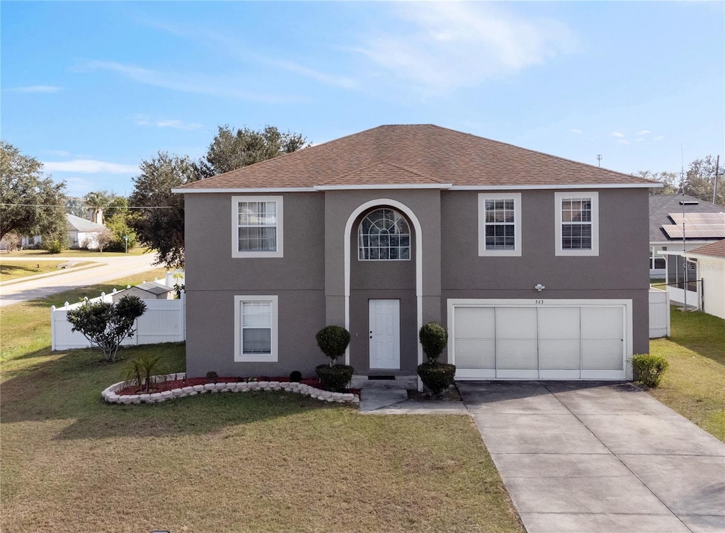 front of property with a garage and a front yard