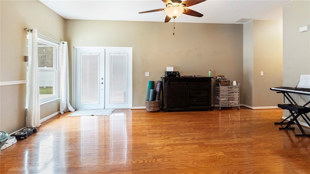 entrance foyer featuring wood-type flooring, ceiling fan, and french doors