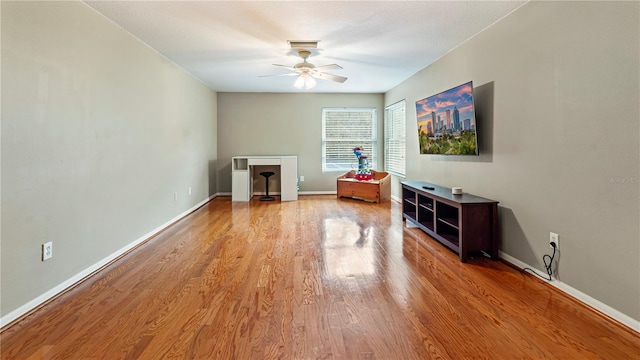 unfurnished living room featuring ceiling fan and light hardwood / wood-style floors