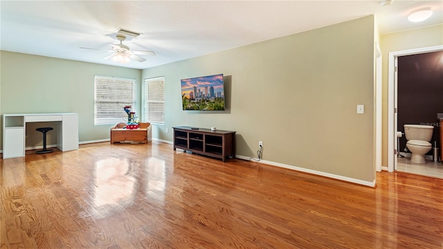 living area with ceiling fan and wood-type flooring