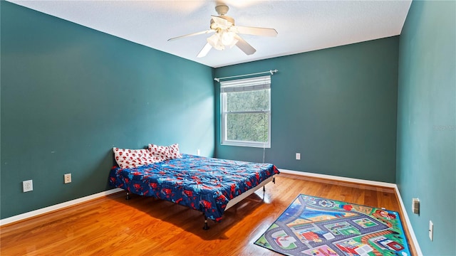 bedroom featuring hardwood / wood-style floors and ceiling fan