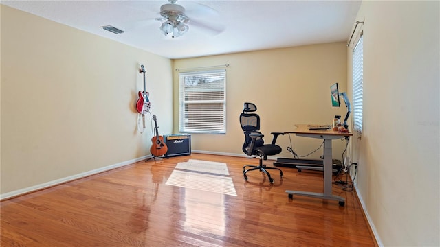 home office featuring hardwood / wood-style floors and ceiling fan