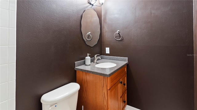 bathroom featuring vanity and toilet