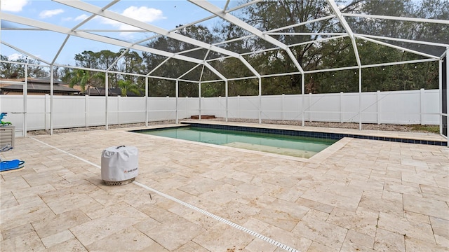 view of swimming pool featuring a lanai and a patio