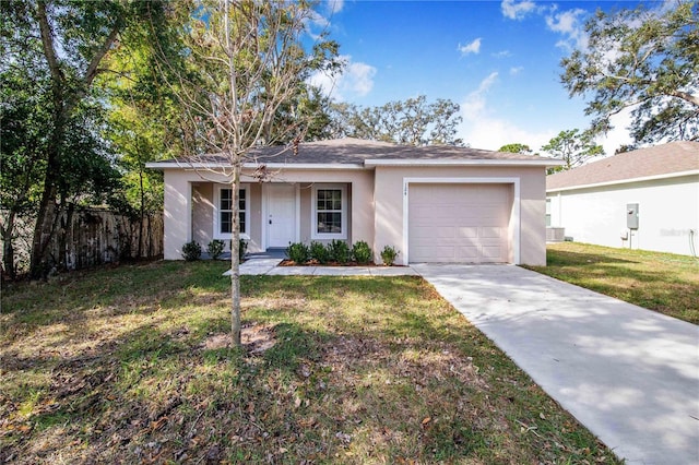 single story home featuring a garage and a front lawn