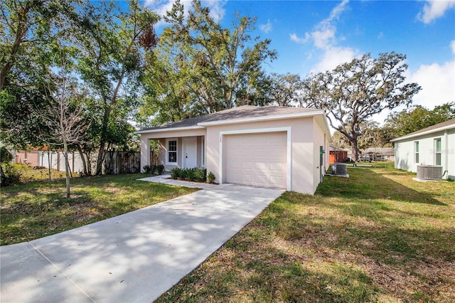 view of front facade with a garage, central AC unit, and a front lawn